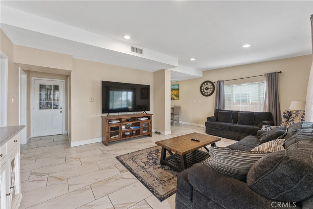 276 East Merrill Avenue Rialto, CA 92376 - Photo 8 of 35 a living room with furniture and a flat screen tv