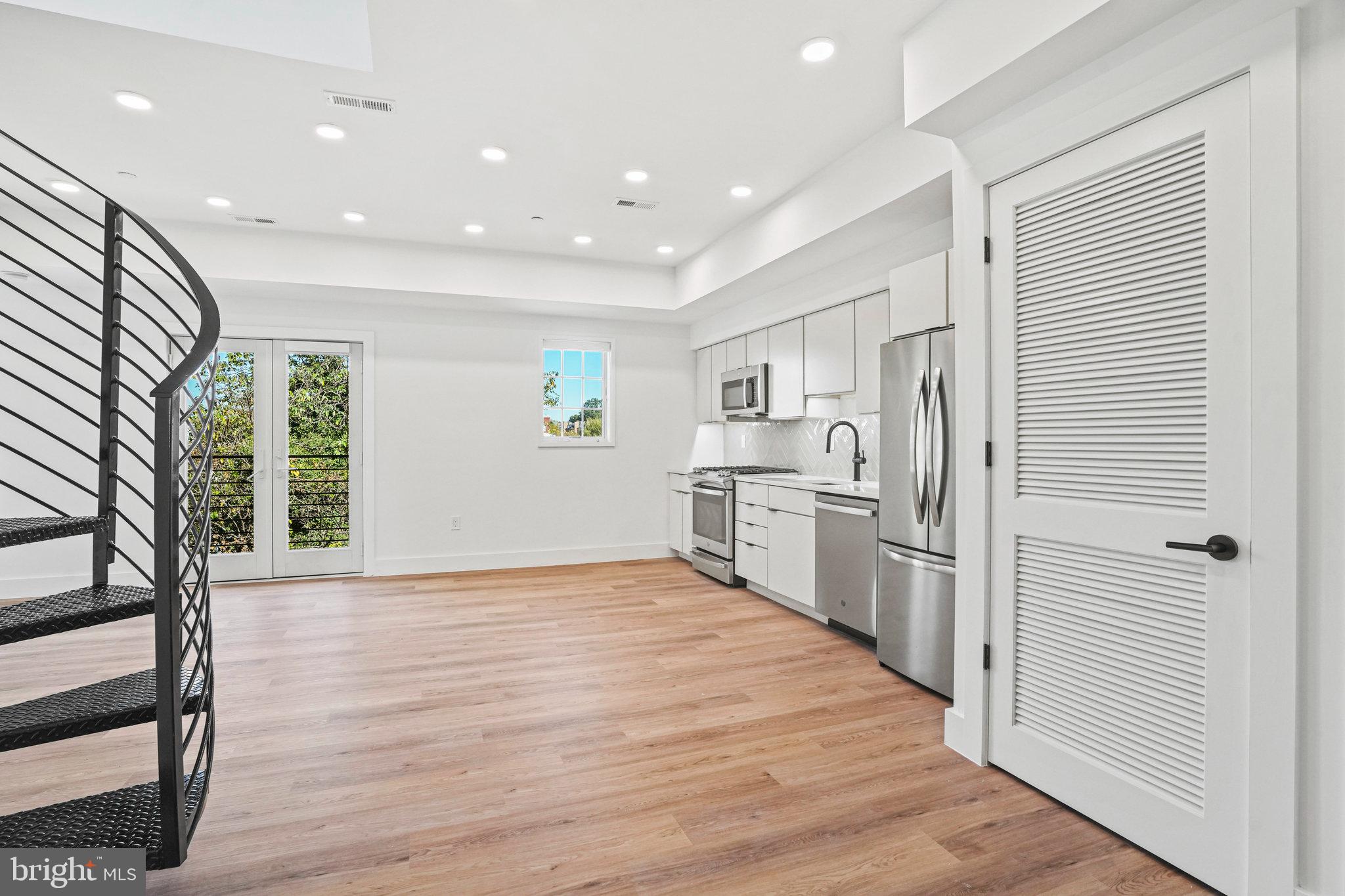 716 L Street Southeast, Unit 403 Washington, DC 20003 - Photo 1 of 17 a kitchen with stainless steel appliances granite countertop a refrigerator and a stove top oven
