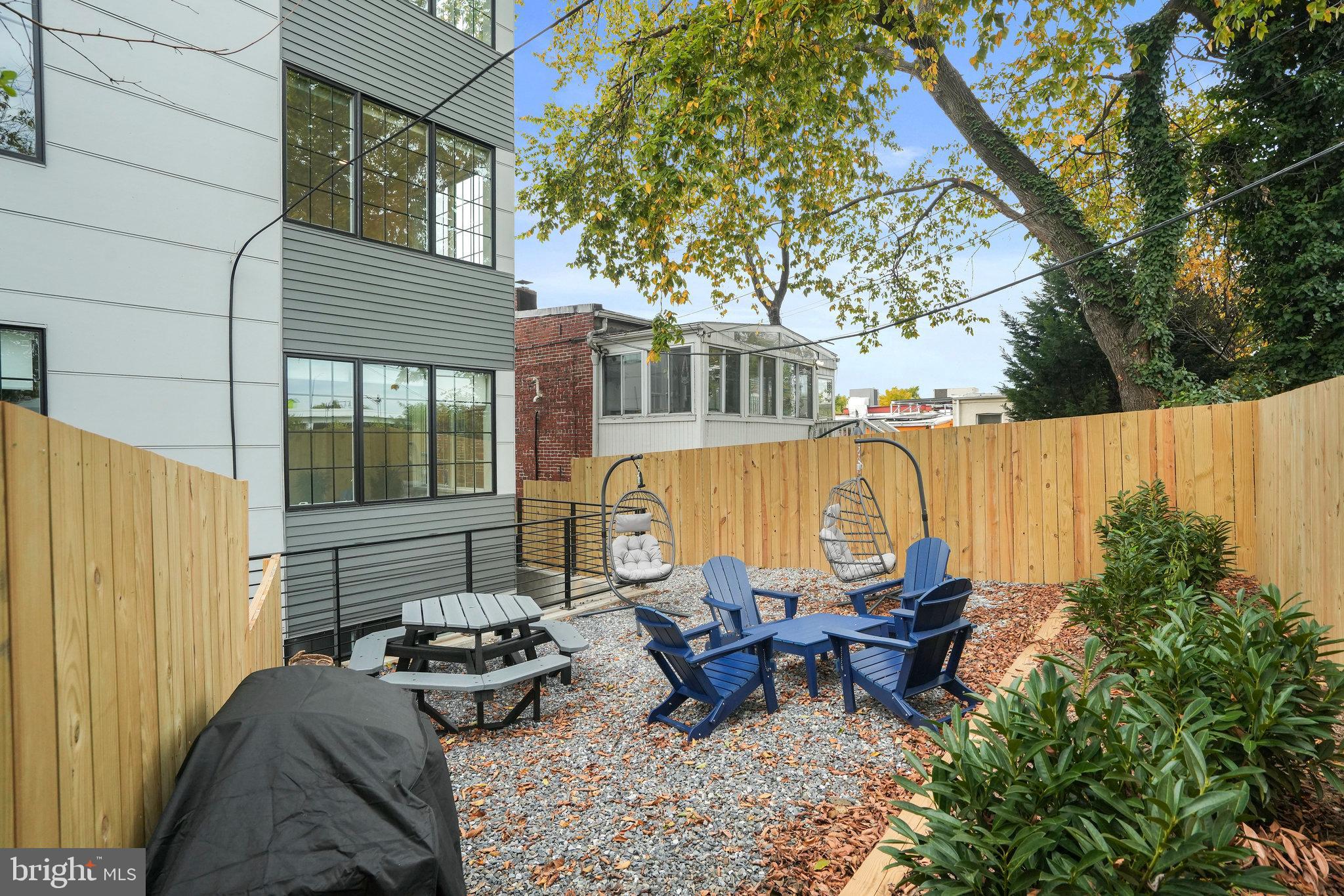 716 L Street Southeast, Unit 403 Washington, DC 20003 - Photo 16 of 17 a backyard of a house with outdoor seating