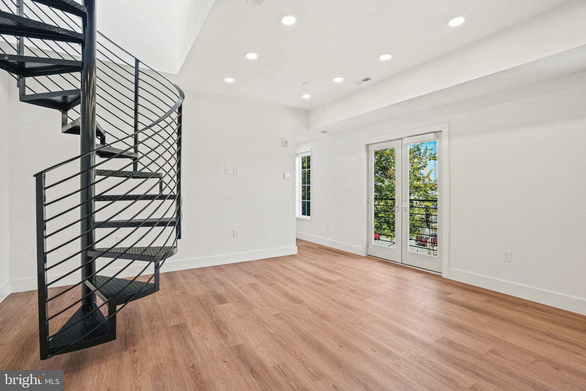 716 L Street Southeast, Unit 403 Washington, DC 20003 - Photo 6 of 17 an empty room with wooden floor and windows