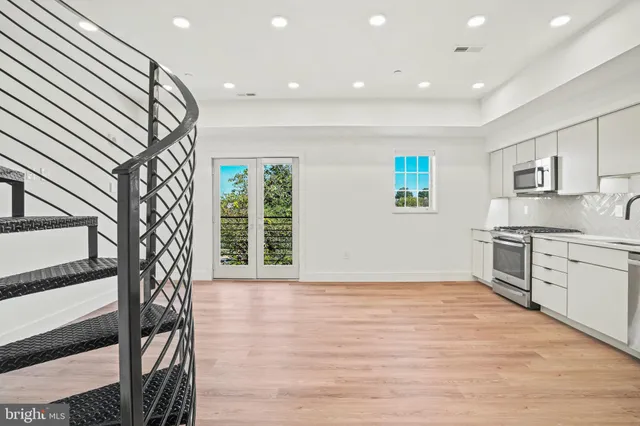 a view of livingroom with kitchen and workspace