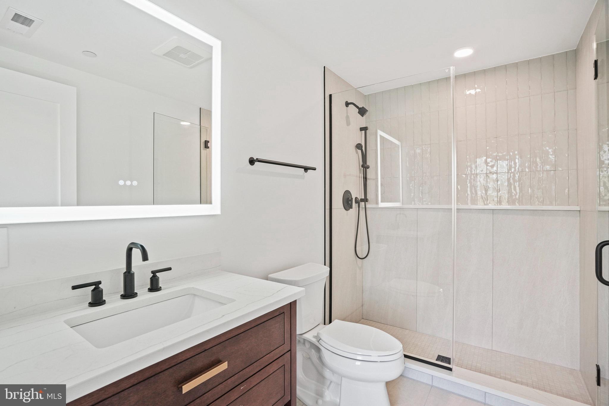 716 L Street Southeast, Unit 403 Washington, DC 20003 - Photo 9 of 17 a bathroom with a sink toilet vanity and shower
