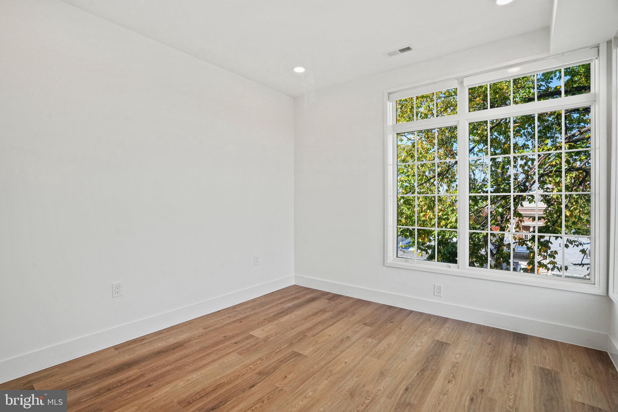 716 L Street Southeast, Unit 403 Washington, DC 20003 - Photo 10 of 17 an empty room with wooden floor and windows