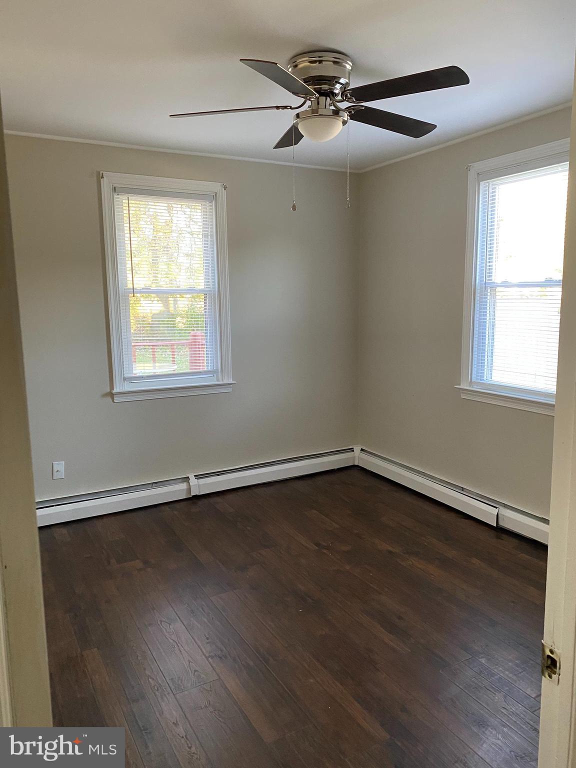 1171 West County Line Road Hatboro, PA 19040 - Photo 11 of 22 a view of an empty room with wooden floor and a window