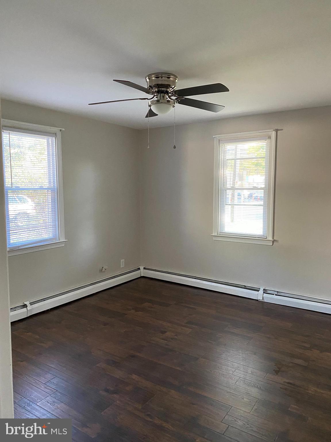1171 West County Line Road Hatboro, PA 19040 - Photo 13 of 22 a view of an empty room with wooden floor and a window