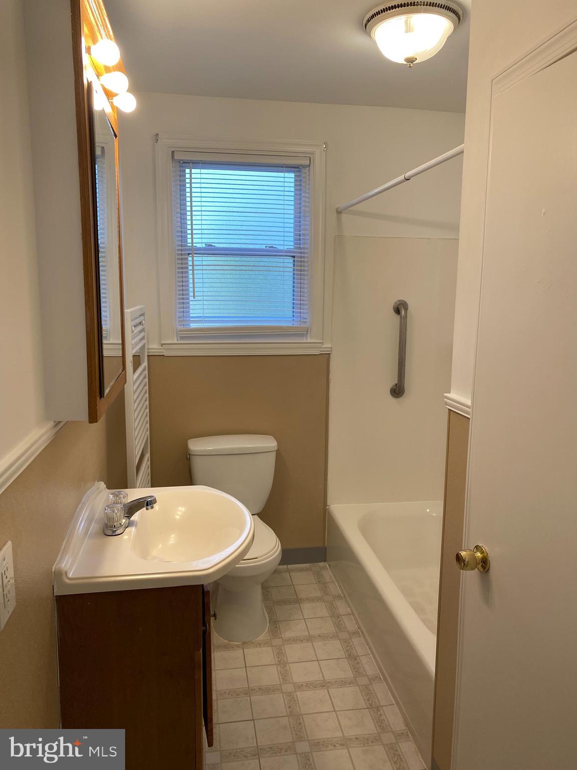 1171 West County Line Road Hatboro, PA 19040 - Photo 14 of 22 a bathroom with a sink a mirror and a bathtub