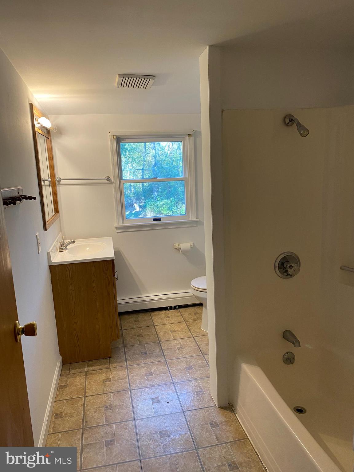 1171 West County Line Road Hatboro, PA 19040 - Photo 19 of 22 a bathroom with a bathtub and toilet