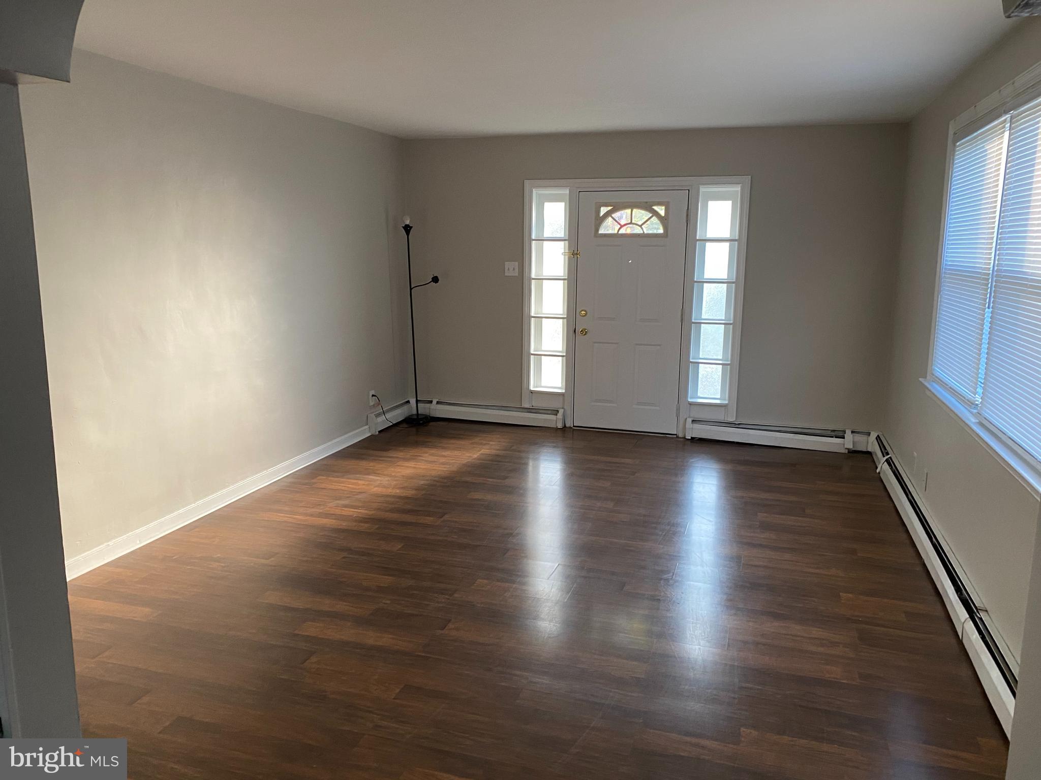1171 West County Line Road Hatboro, PA 19040 - Photo 9 of 22 an empty room with wooden floor and windows