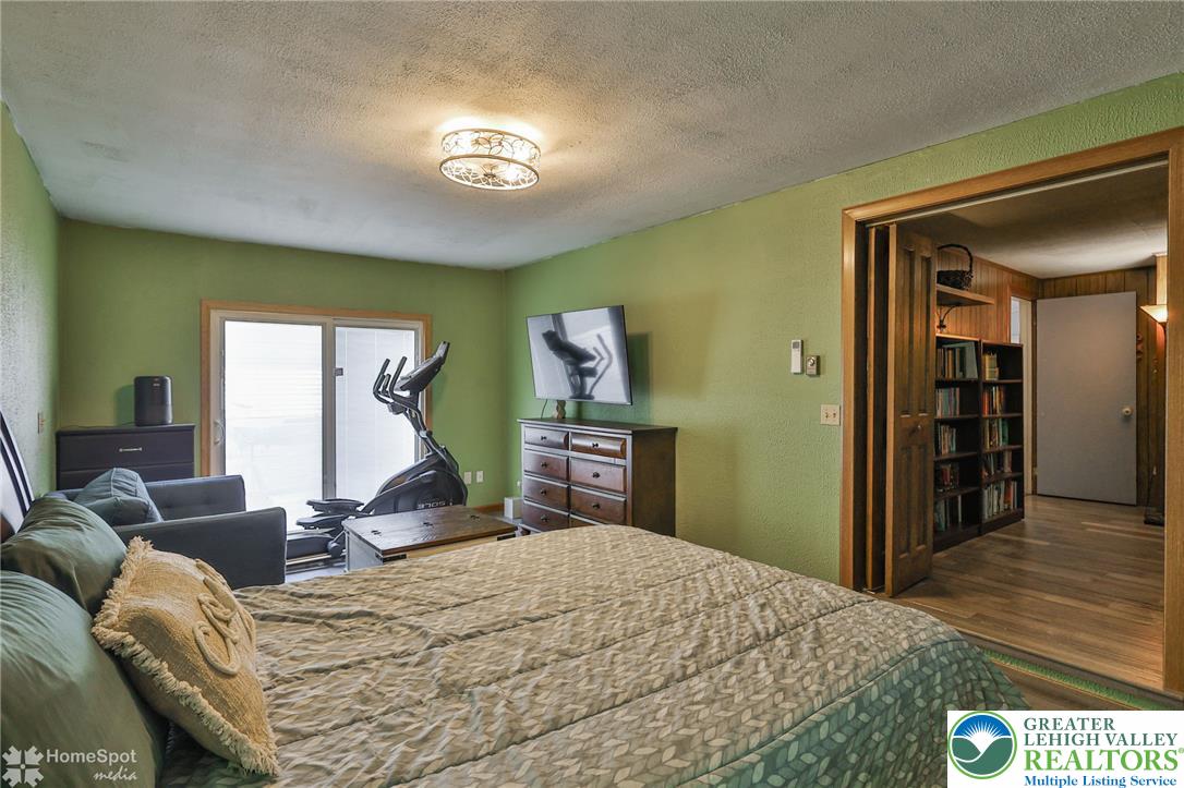 60 Sassafras Road Lehighton, PA 18235 - Photo 29 of 36 A well-lit bedroom provides direct outdoor access and seamless transition to a home library.