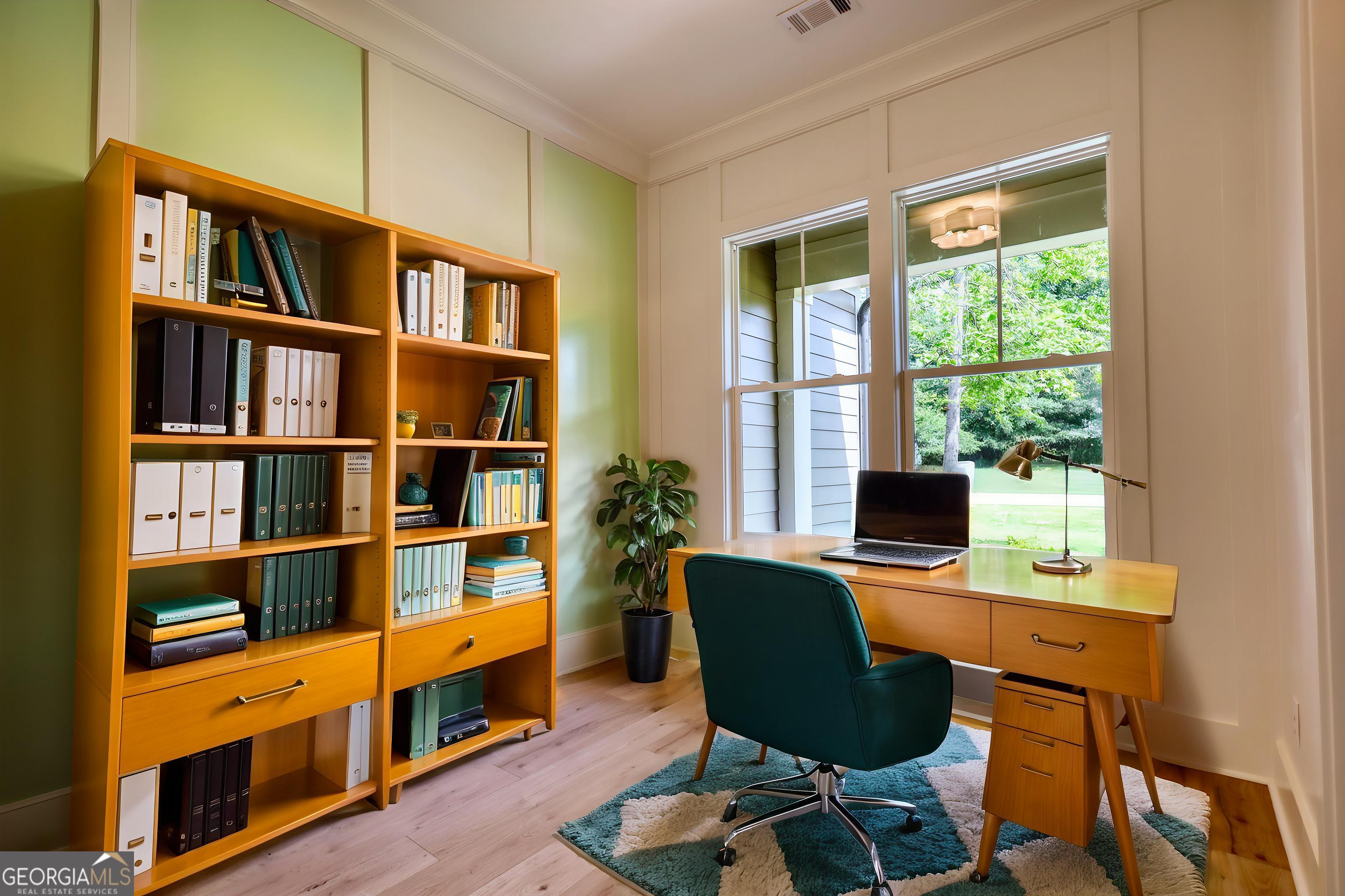 1031 Graham Drive Madison, GA 30650 - Photo 19 of 78 a view of a workspace with furniture and a bookshelf