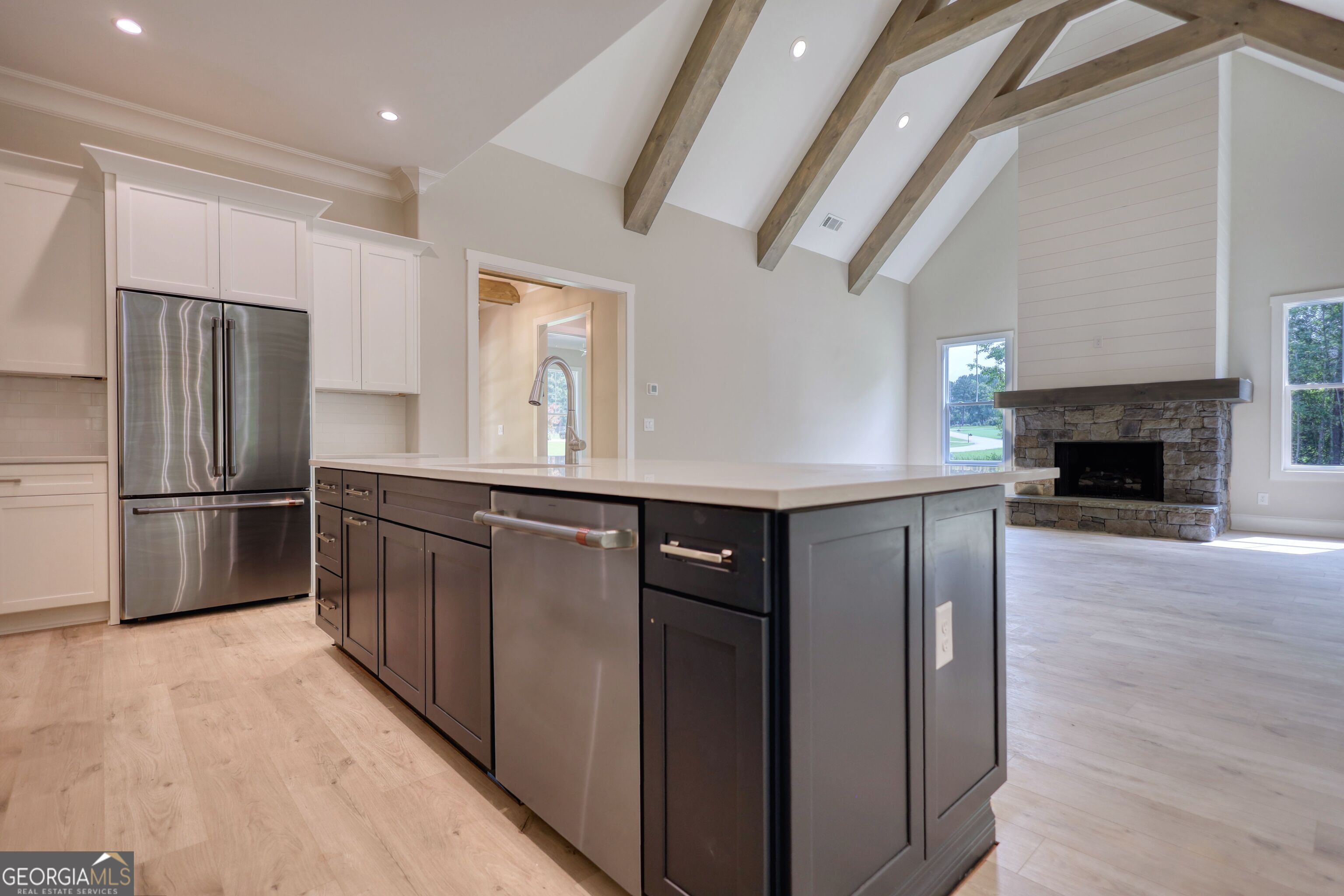 1031 Graham Drive Madison, GA 30650 - Photo 31 of 78 a kitchen with stainless steel appliances a refrigerator and a fireplace