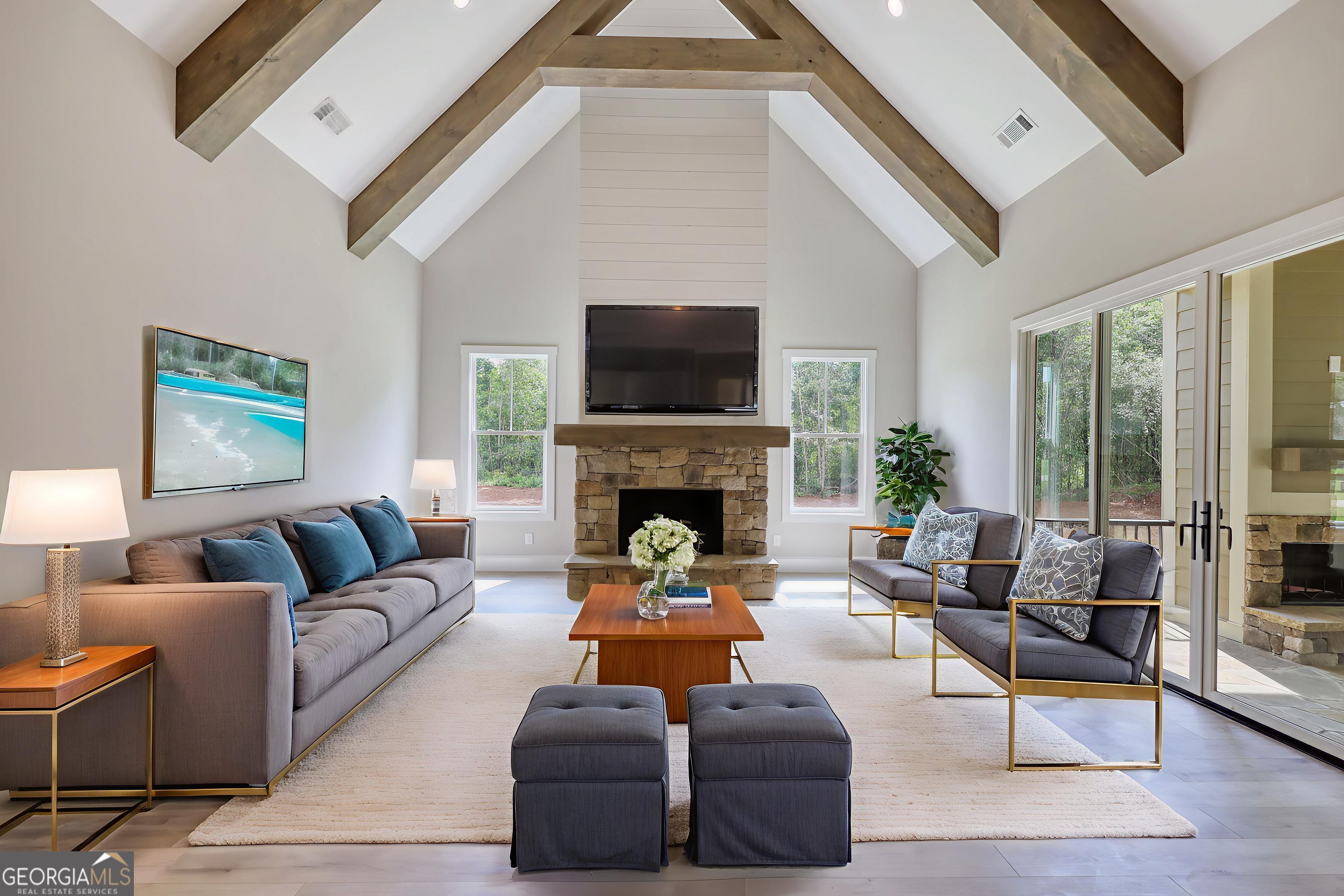 1031 Graham Drive Madison, GA 30650 - Photo 37 of 78 a living room with furniture a flat screen tv and a fireplace