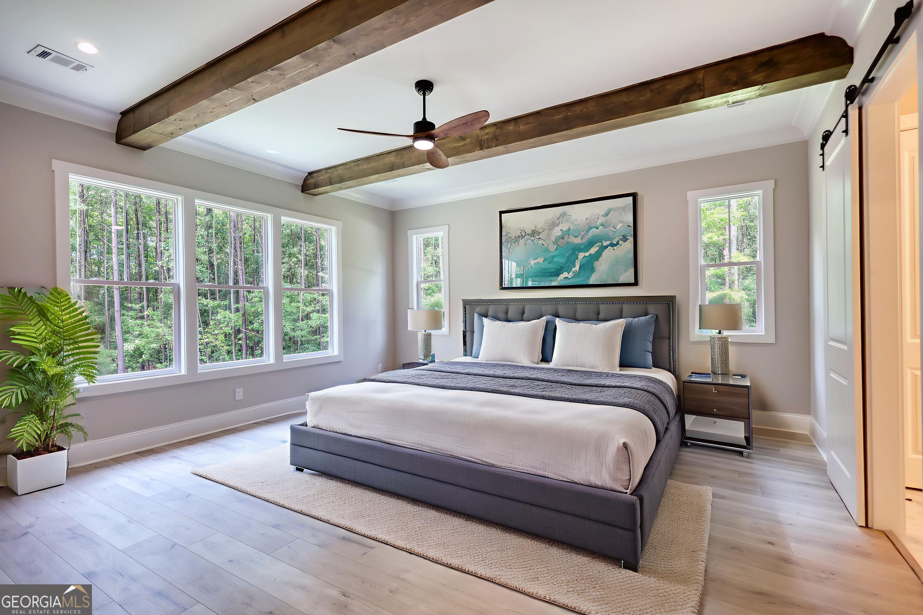 1031 Graham Drive Madison, GA 30650 - Photo 49 of 78 a spacious bedroom with a large bed and a window