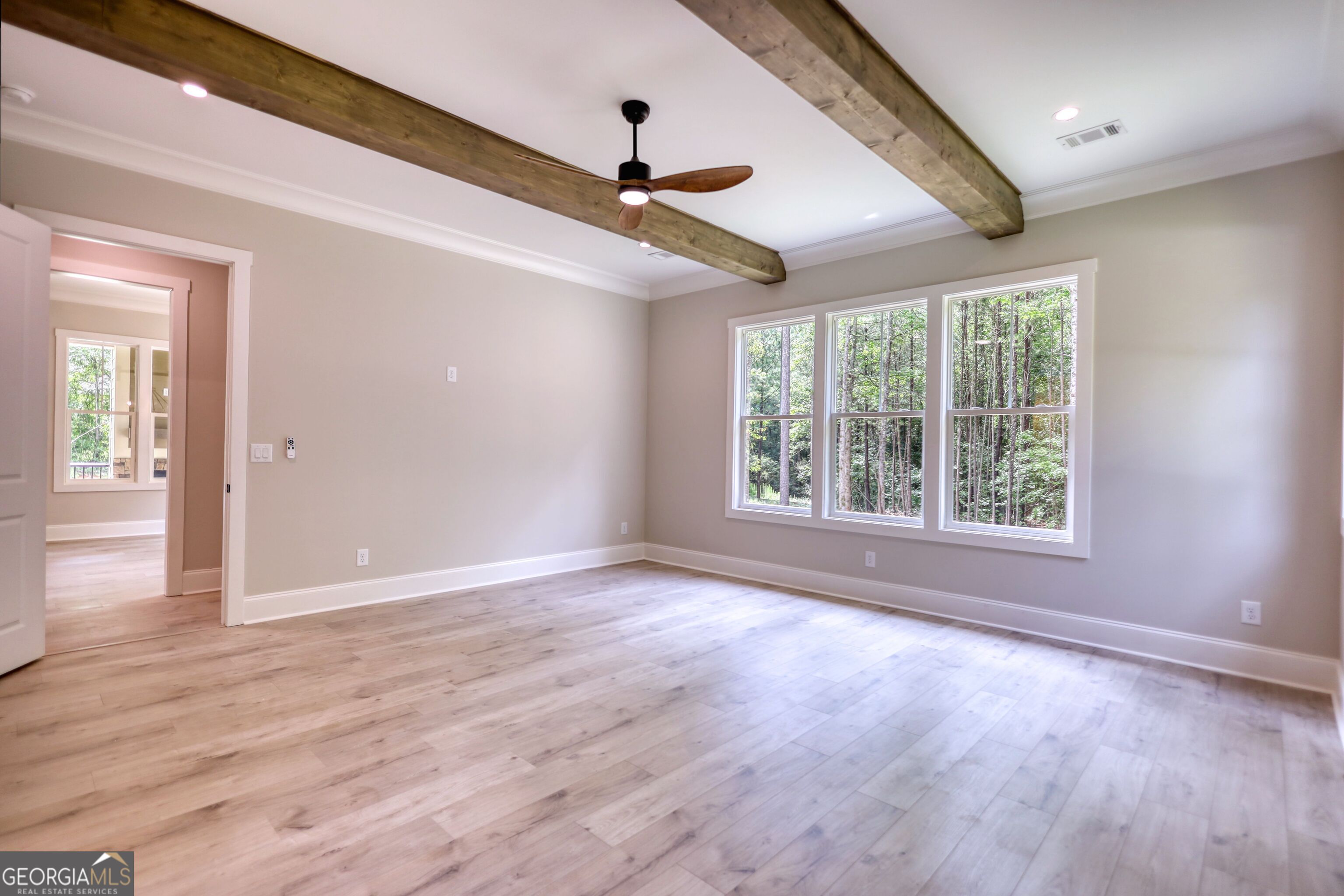 1031 Graham Drive Madison, GA 30650 - Photo 52 of 78 an empty room with wooden floor chandelier and windows