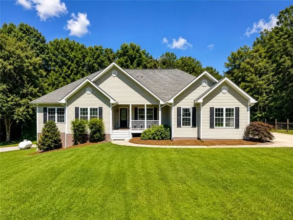 a front view of a house with a yard and porch
