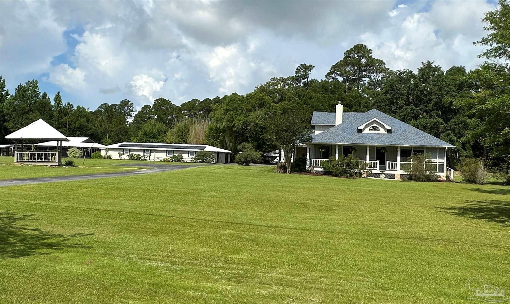3375 Robinson Point Road Milton, FL 32583 - Photo 1 of 50 a front view of a house with garden