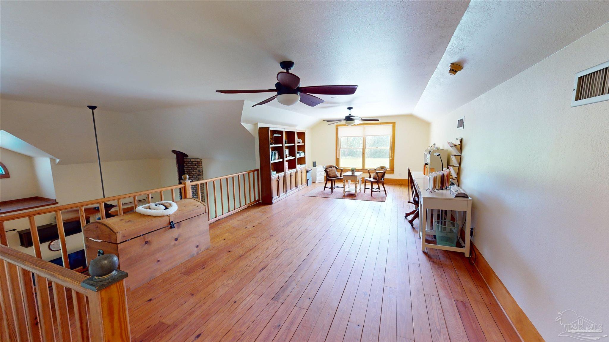 3375 Robinson Point Road Milton, FL 32583 - Photo 22 of 50 a very nice looking room with wooden floor and furniture