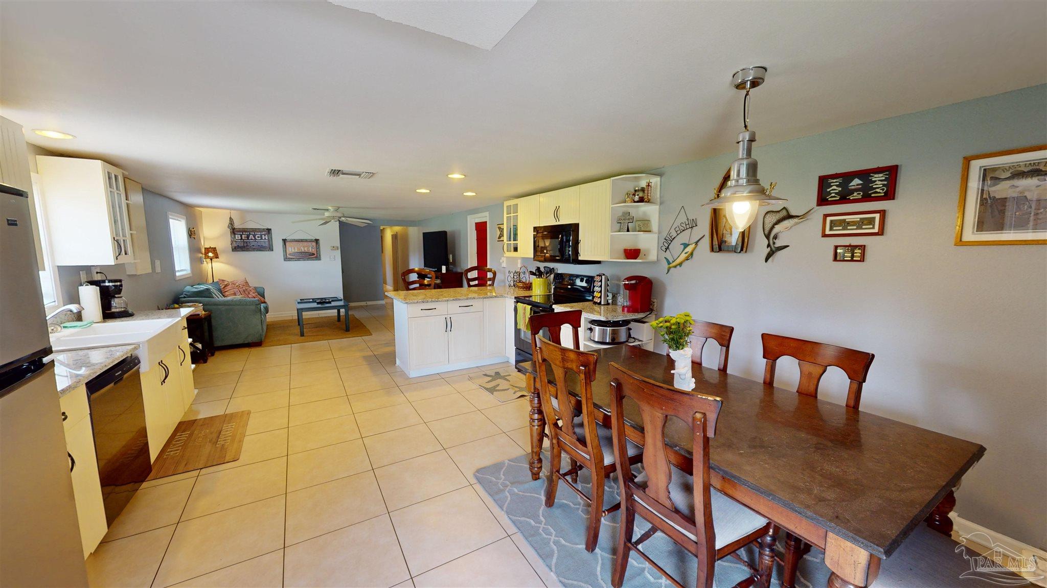 3375 Robinson Point Road Milton, FL 32583 - Photo 25 of 50 a living room with furniture and a kitchen view