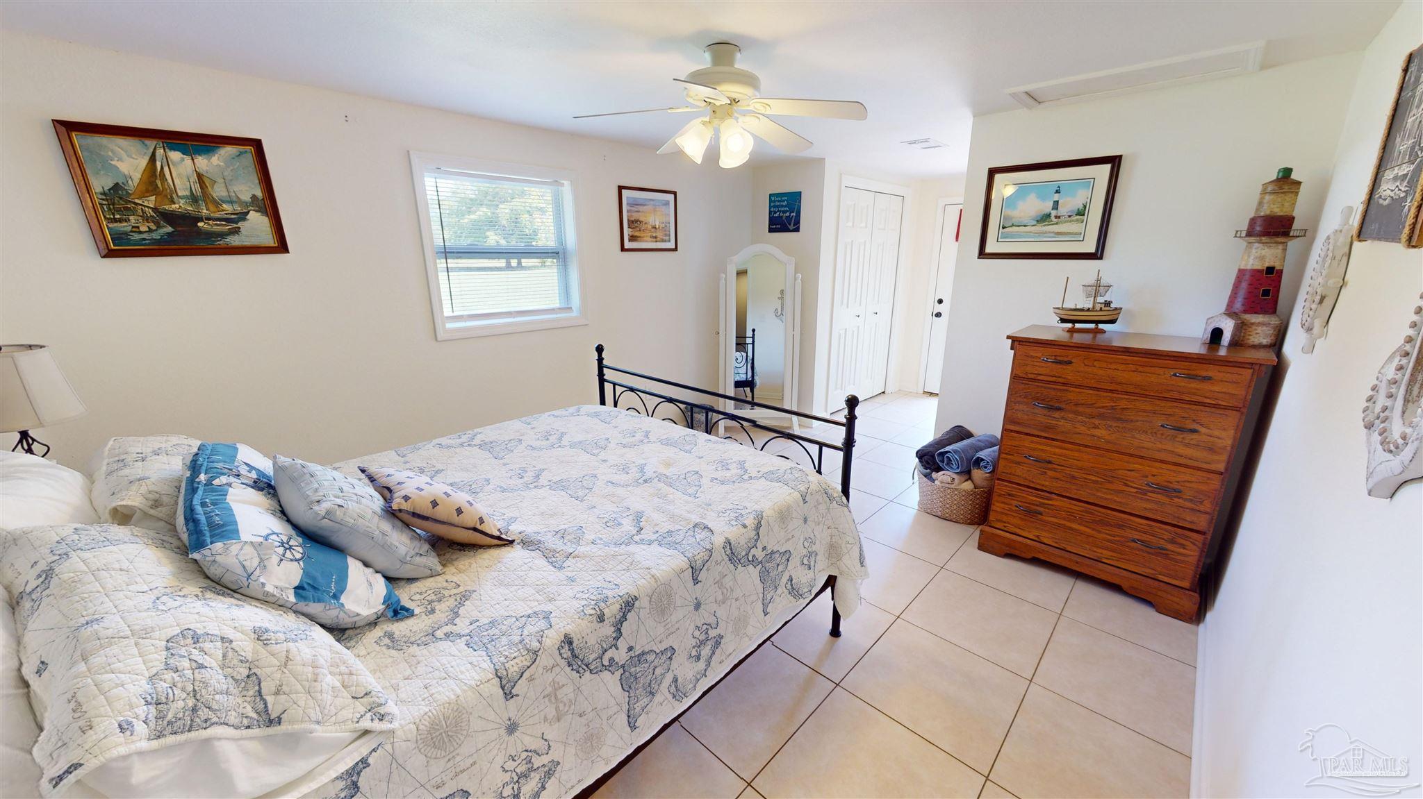 3375 Robinson Point Road Milton, FL 32583 - Photo 29 of 50 a bedroom with a bed and a dresser