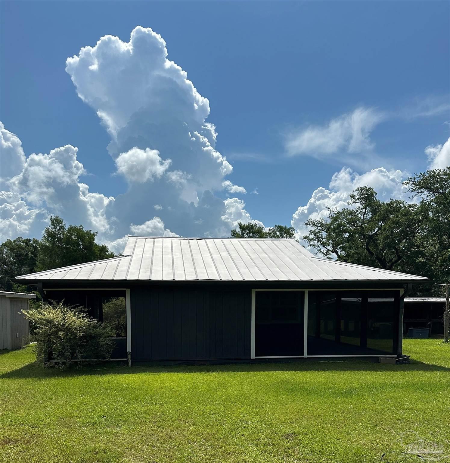 3375 Robinson Point Road Milton, FL 32583 - Photo 32 of 50 a view of house with backyard and a swimming pool