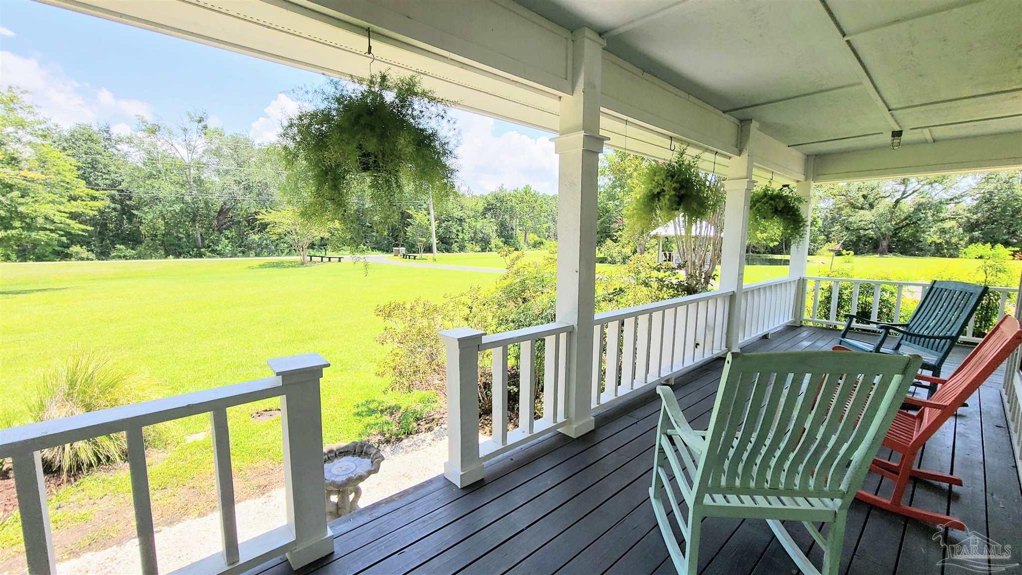 3375 Robinson Point Road Milton, FL 32583 - Photo 4 of 50 a view of a porch with furniture and wooden floor