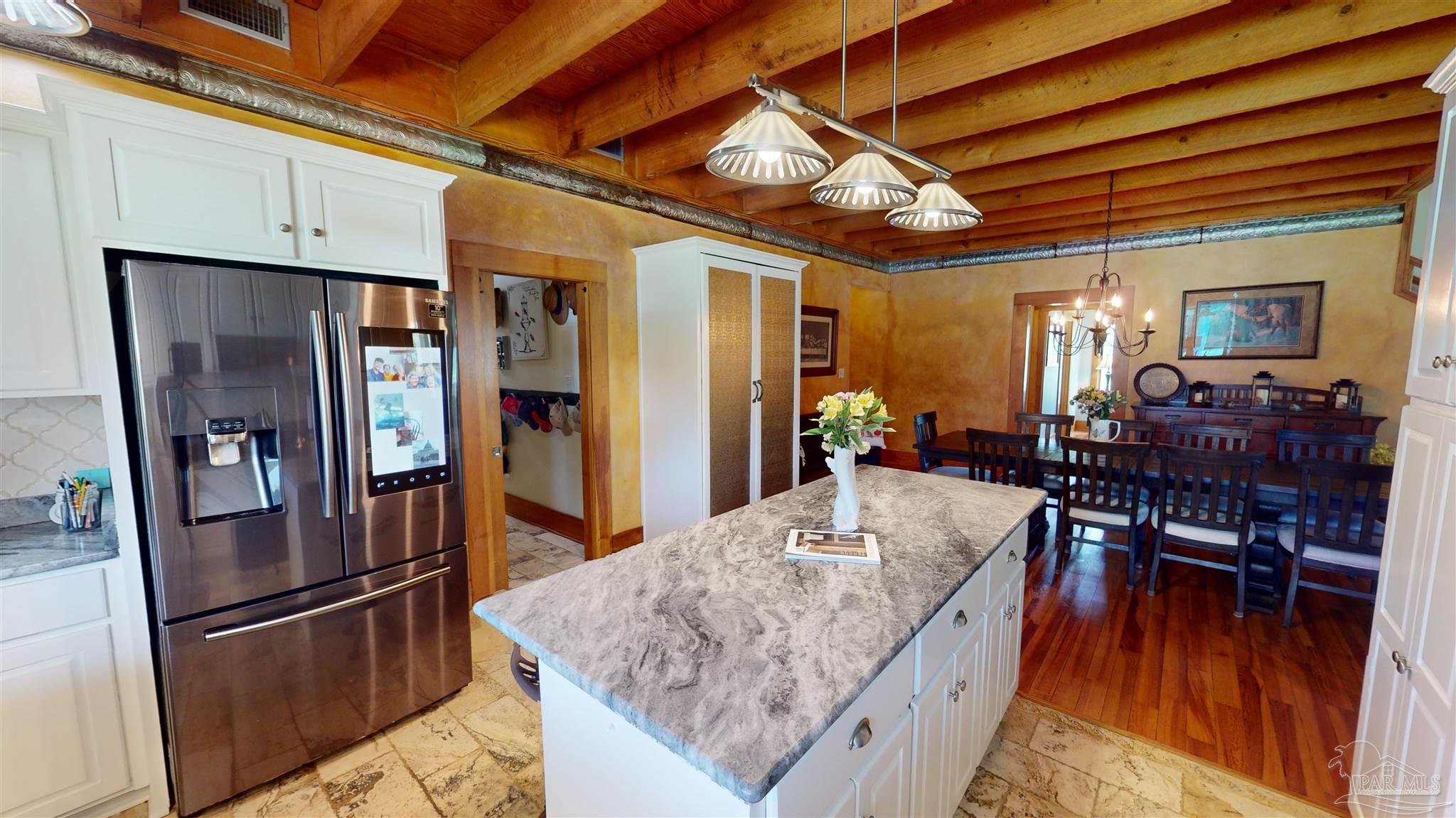 3375 Robinson Point Road Milton, FL 32583 - Photo 10 of 50 a kitchen with stainless steel appliances granite countertop a refrigerator a stove and a dining table