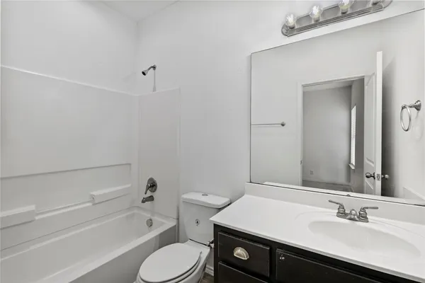 a bathroom with a sink a toilet and bathtub