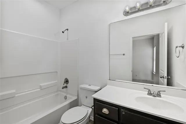 a bathroom with a sink a toilet and bathtub
