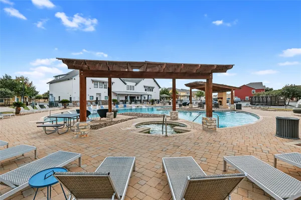 a view of a swimming pool with a patio