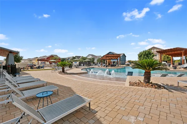 an outdoor space with patio and white umbrellas
