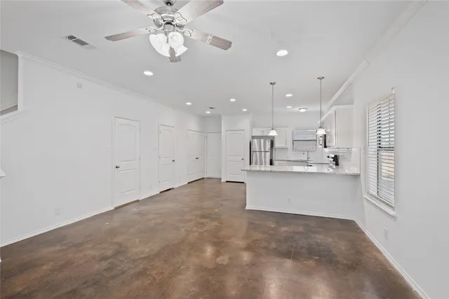 a view of kitchen with center island and stainless steel appliances