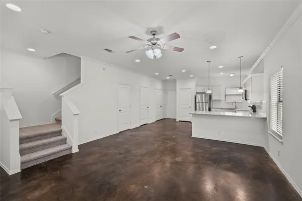 a view of kitchen and hall with wooden floor