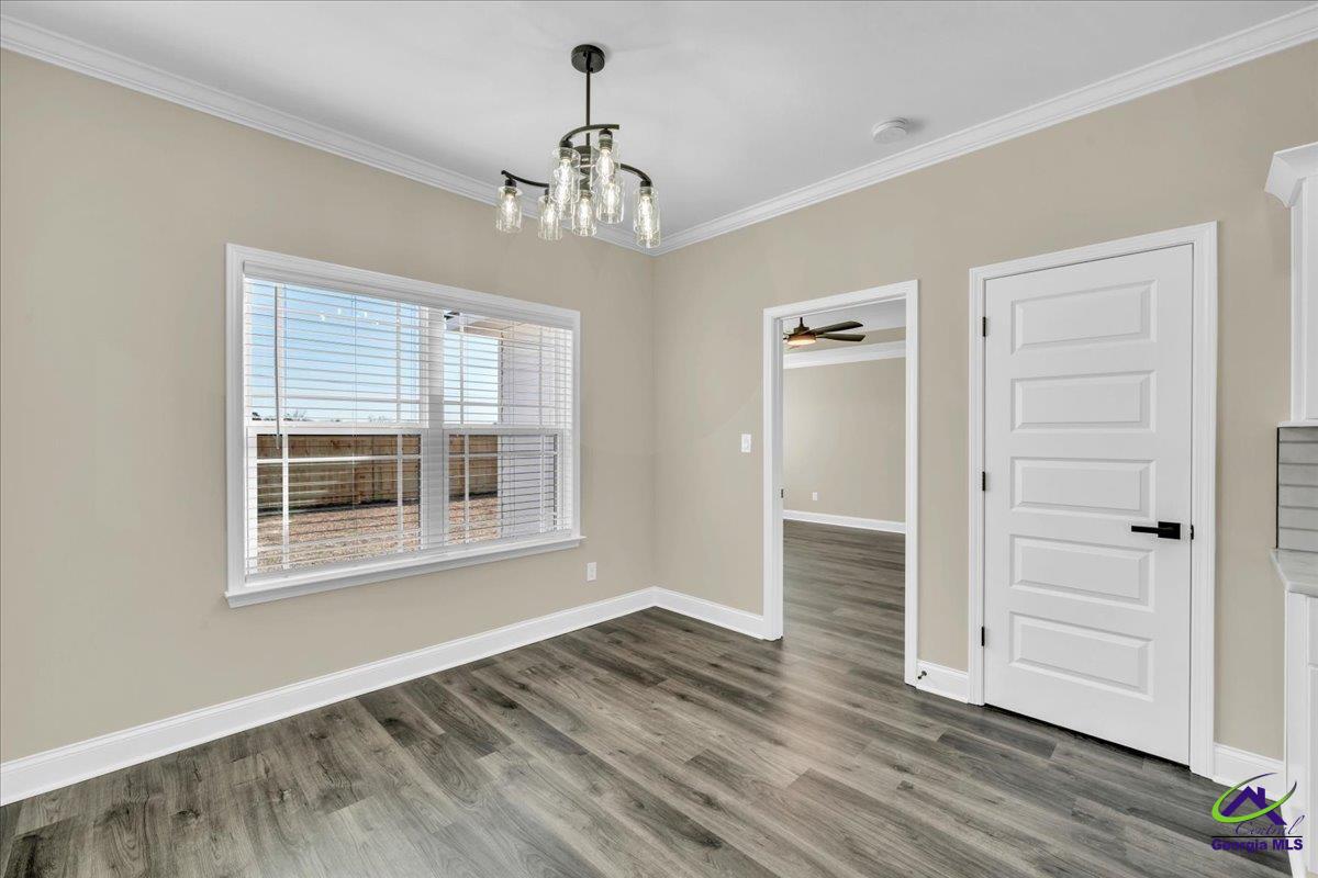 103 Early Drive Byron, GA 31008 - Photo 22 of 56 a view of an empty room with wooden floor and a window