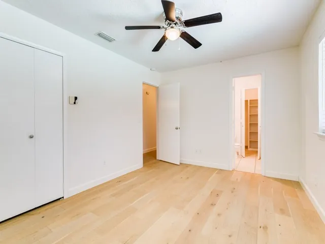 a view of empty room with ceiling fan