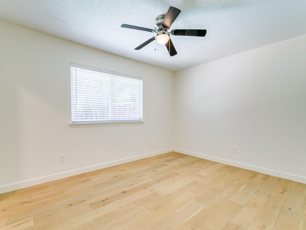510 Copper Ridge Drive Richardson, TX 75080 - Photo 13 of 25 an empty room with a window and a fan