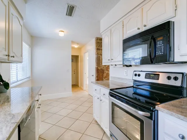a kitchen with a stove and a microwave
