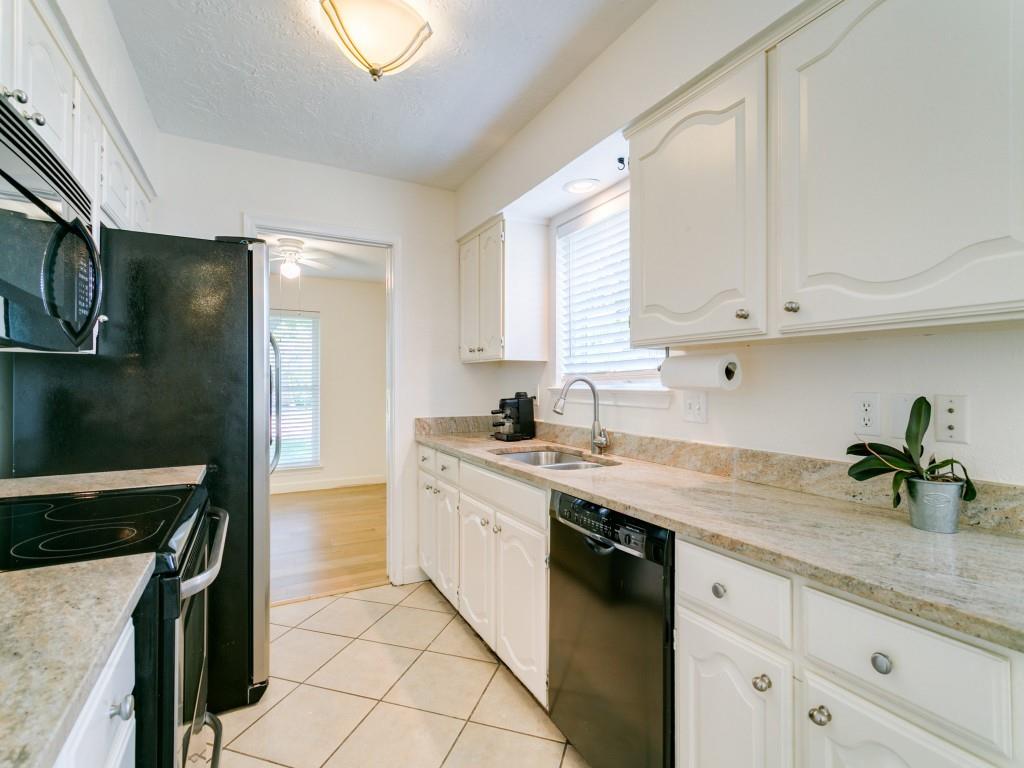 510 Copper Ridge Drive Richardson, TX 75080 - Photo 17 of 25 a kitchen with a sink dishwasher a stove and a refrigerator