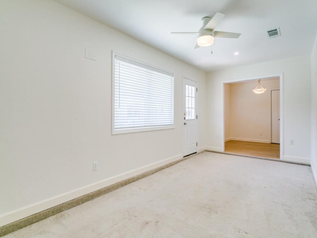510 Copper Ridge Drive Richardson, TX 75080 - Photo 21 of 25 an empty room with chandelier fan and windows