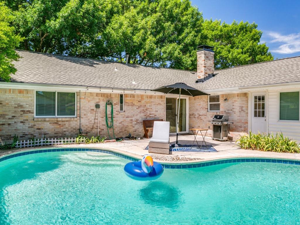 510 Copper Ridge Drive Richardson, TX 75080 - Photo 23 of 25 a swimming pool with outdoor seating yard and a tree