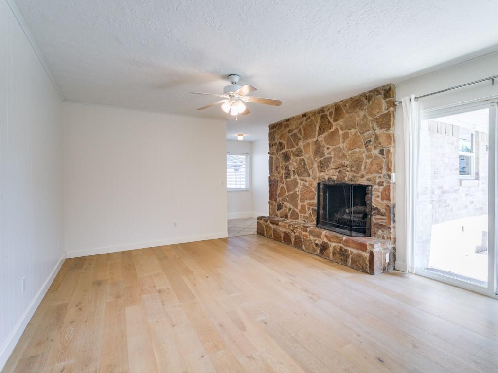 510 Copper Ridge Drive Richardson, TX 75080 - Photo 6 of 25 wooden floor fireplace and windows in an empty room