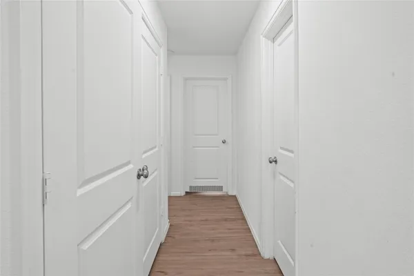 a view of a hallway with the wooden floor