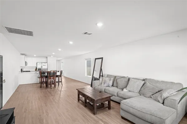 a living room with furniture and kitchen view