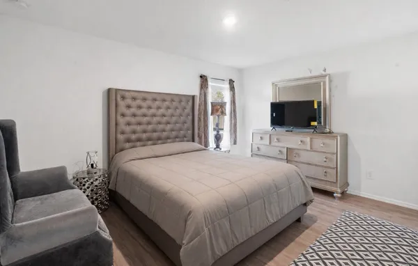 a bedroom with a bed and a flat screen tv