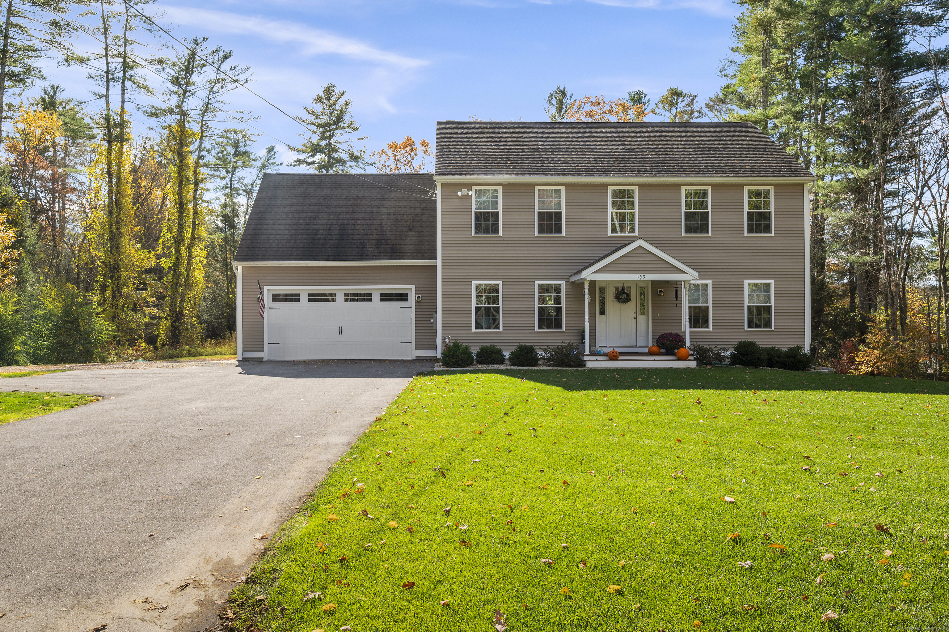 153 Wauregan Road Canterbury, CT 06331 - Photo 1 of 40 a front view of a house with a yard and garage