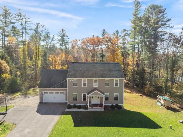 a view of a house with a yard and mountain view
