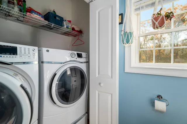 a view of a dining room with furniture and a window