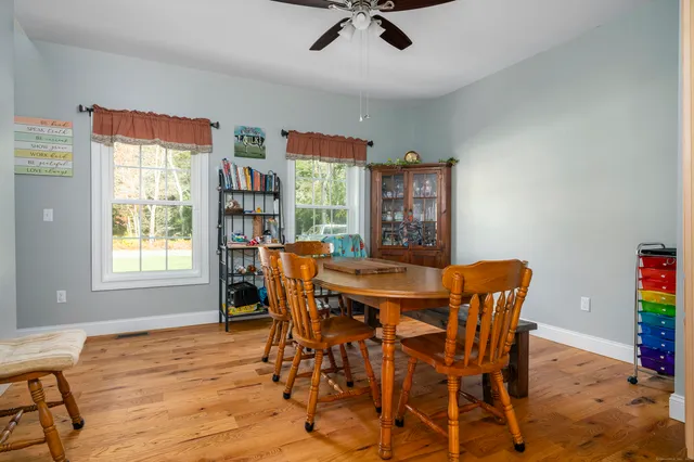 a view of a dining room with furniture and wooden floor