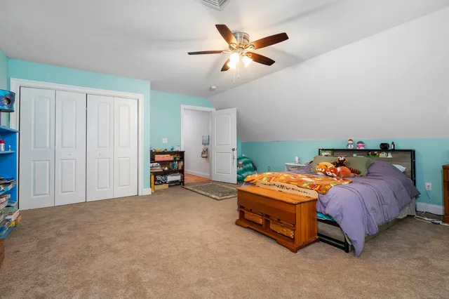 a bedroom with a bed and a wooden floor