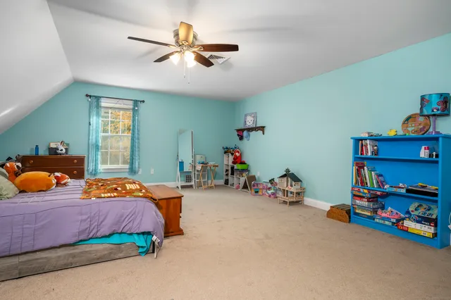 a bedroom with bed and window