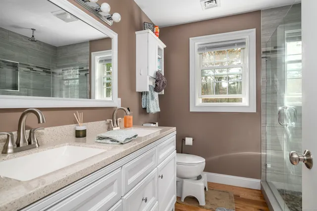 a room with stainless steel appliances kitchen island granite countertop lots of clutter